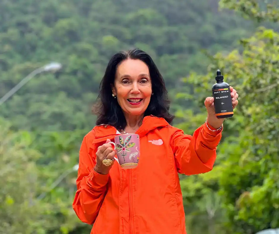 Woman holding mug and bottle.