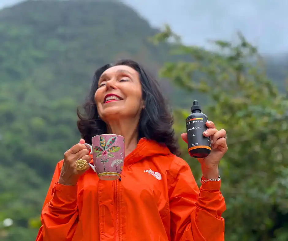 Woman holding mug and bottle.